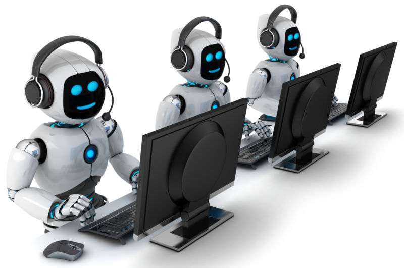 Three robots sitting in front of computers and wearing phone headsets.